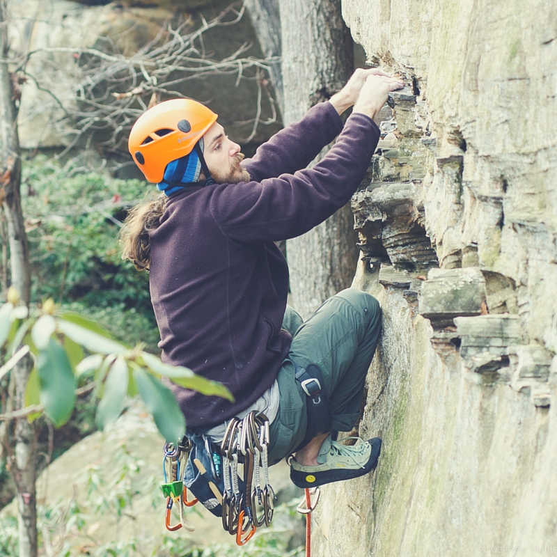 Jason Talis climbing a Rock Wall 